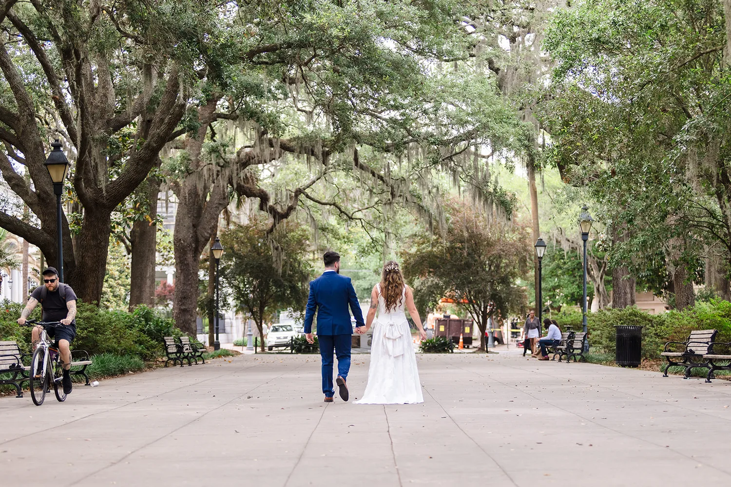 Bride and groom walking under Savannah oak trees