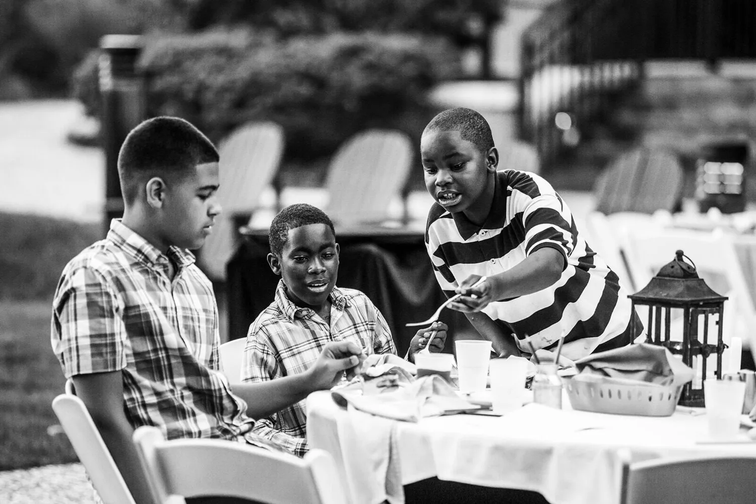 Black and white family moment at a wedding reception table
